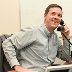 Dexcomm dedicated account manager taking a phone call and smiling