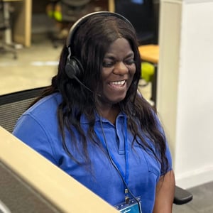 Dexcomm agent laughing while answering a call in call center