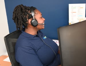 Dexcomm call center employee smiling while answering a call