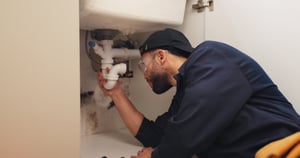 Plumber fixing pipes